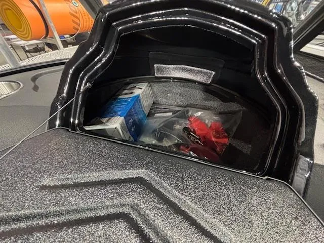 Slide: The Image of Storage compartment of 2025 Crestliner 1750 Super Hawk WT JS boat, containing various items. - 12
