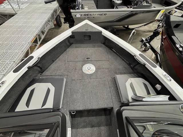 Slide: The Image of 2025 Crestliner 1750 Super Hawk WT JS boat interior with seating and storage. - 13