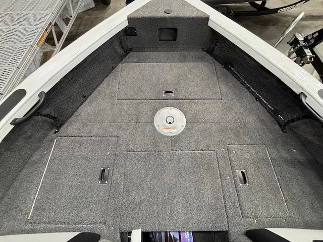 Slide: The Image of 2025 Crestliner 1750 Super Hawk WT JS boat interior with carpeted deck and storage compartments. - 14