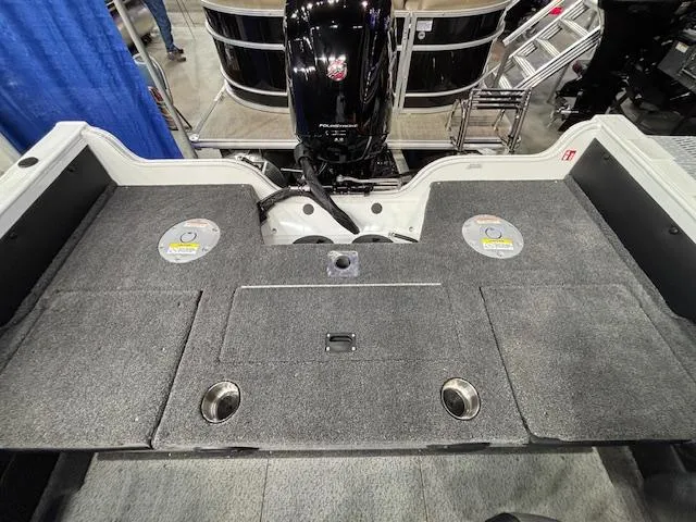 Slide: The Image of 2025 Crestliner 1750 Super Hawk WT JS boat deck with motor and carpeted surface. - 20