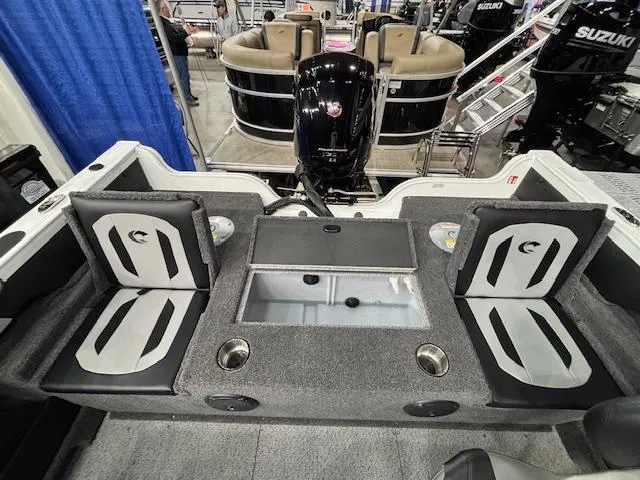 Slide: The Image of 2025 Crestliner 1750 Super Hawk WT JS interior with seating and motor, showcased at a boat event. - 21