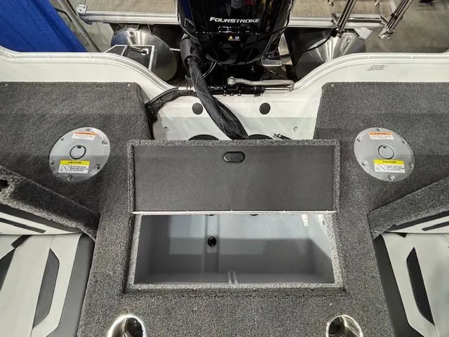 Slide: The Image of 2025 Crestliner 1750 Super Hawk WT JS boat interior with storage compartment and motor. - 22