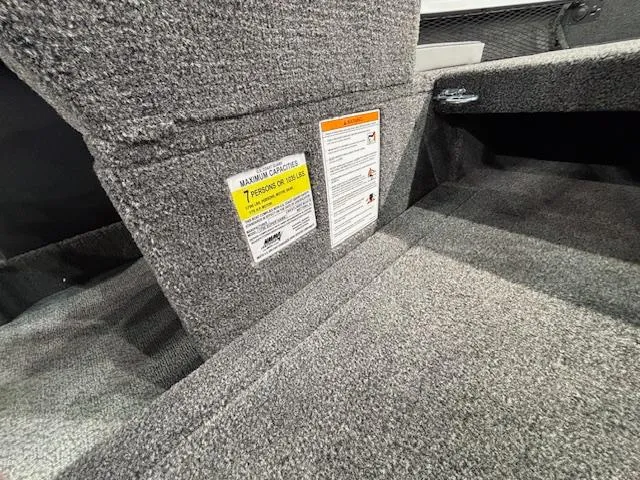 Slide: The Image of 2025 Crestliner 1750 Super Hawk WT JS interior storage compartment with safety label. - 9