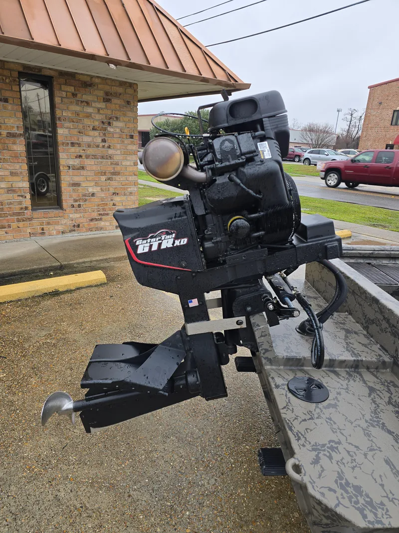 Slide: The Image of 2022 Gator Tail 1860 Extreme CC boat with powerful outboard motor, parked outdoors. - 3