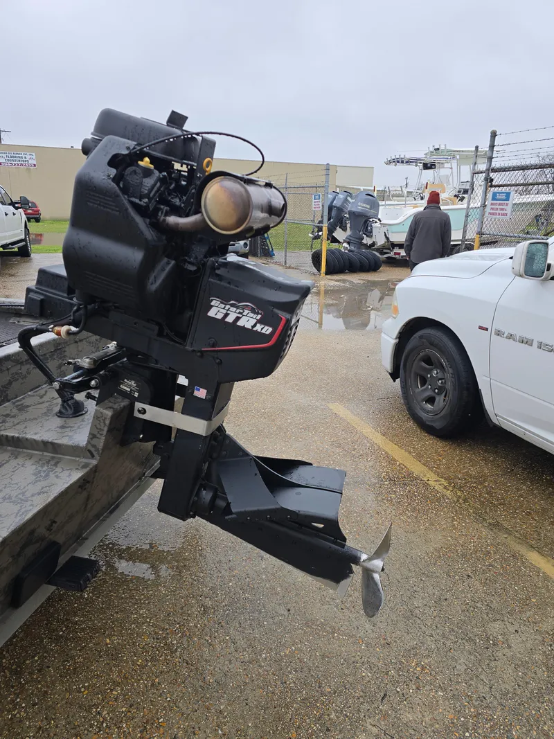 Slide: The Image of 2022 Gator Tail 1860 Extreme CC boat motor in a parking lot. - 5