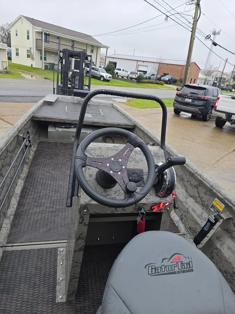 Slide: The Image of 2022 Gator Tail 1860 Extreme CC boat, featuring steering console and urban background. - 8