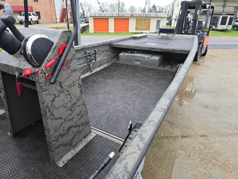 Slide: The Image of 2022 Gator Tail 1860 Extreme CC boat, camo design, spacious deck, parked outdoors. - 9