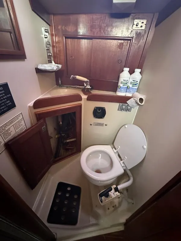 Slide: The Image of Compact bathroom in 1985 Ericson 30 Plus sailboat with toilet and wooden cabinetry. - 10