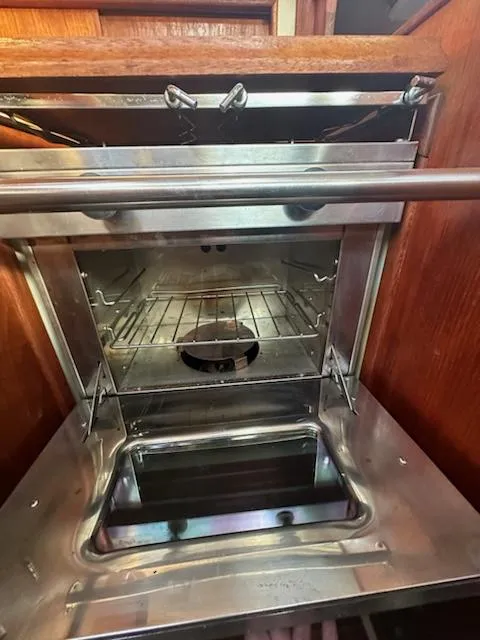 Slide: The Image of 1985 Ericson 30 Plus yacht interior oven with stainless steel finish and open door. - 15