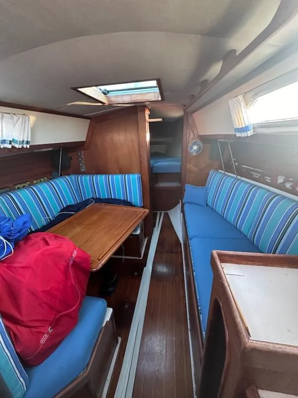 Slide: The Image of Interior of 1985 Ericson 30 Plus sailboat with blue-striped seating and wooden finishes. - 18