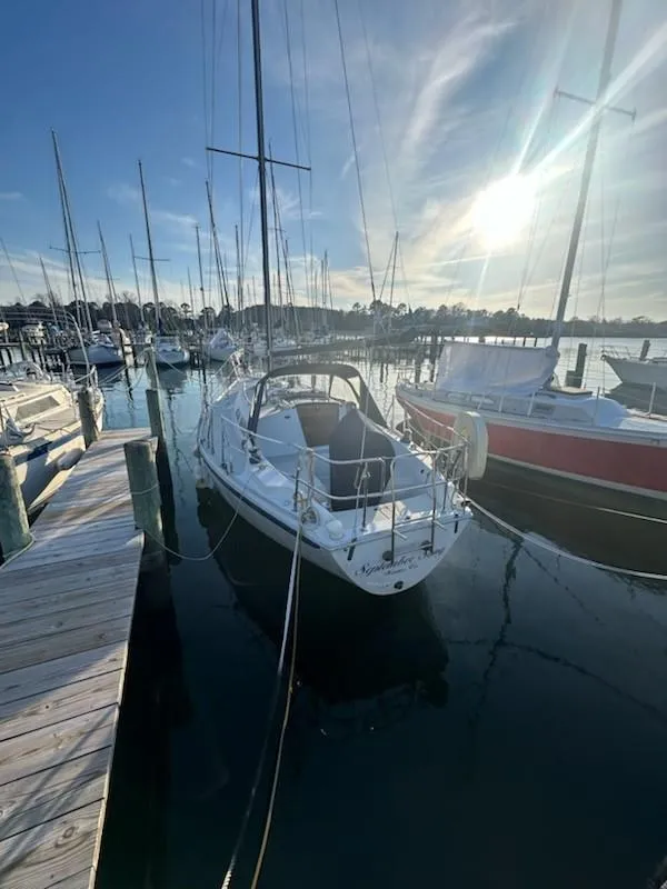 Slide: The Image of 1985 Ericson 30 Plus sailboat docked in a sunny marina. - 2