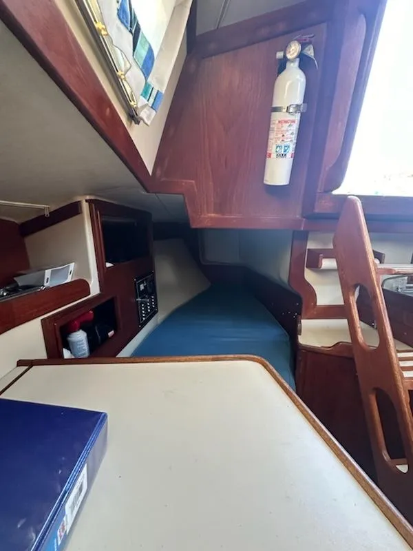 Slide: The Image of Interior of 1985 Ericson 30 Plus sailboat with wooden cabinetry and fire extinguisher. - 20