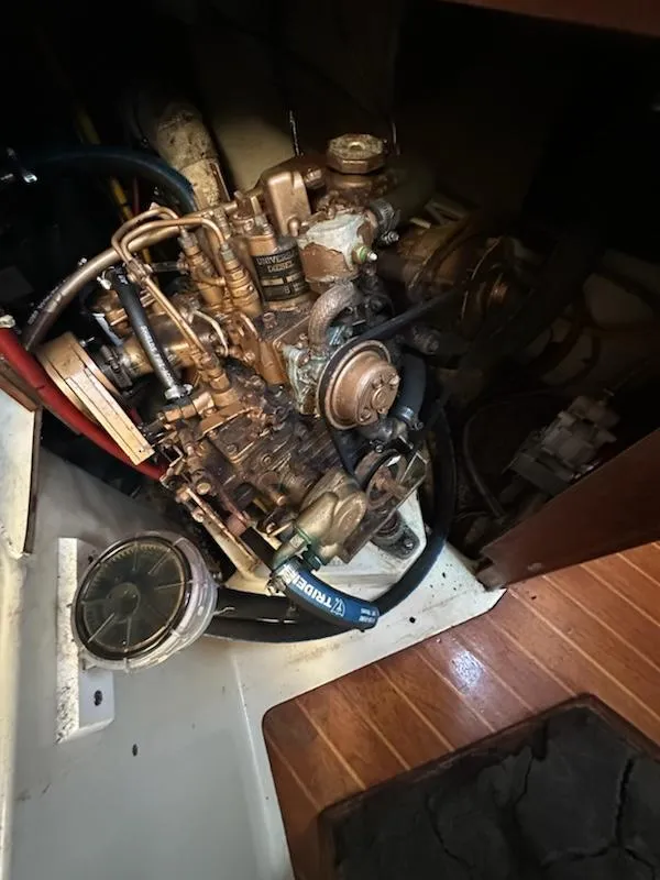Slide: The Image of Engine compartment of a 1985 Ericson 30 Plus sailboat, showcasing mechanical components. - 29
