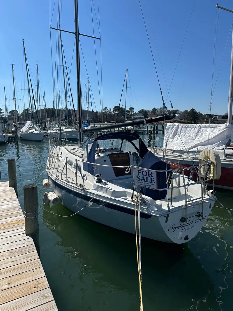 Slide: The Image of 1985 Ericson 30 Plus sailboat docked, "For Sale" sign visible, sunny marina setting. - 47
