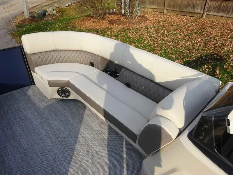 Slide: The Image of 2024 Harris Sunliner 230 boat interior with beige seating and gray flooring. - 10