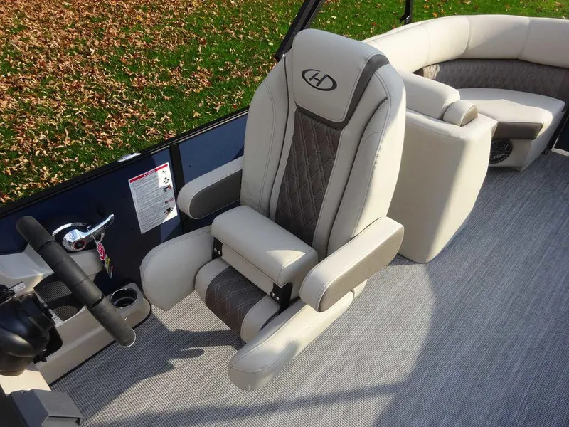 Slide: The Image of 2024 Harris Sunliner 230 boat interior with plush seating and modern design. - 14
