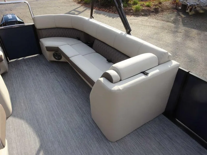 Slide: The Image of 2024 Harris Sunliner 230 boat interior with beige seating and carpeted flooring. - 6