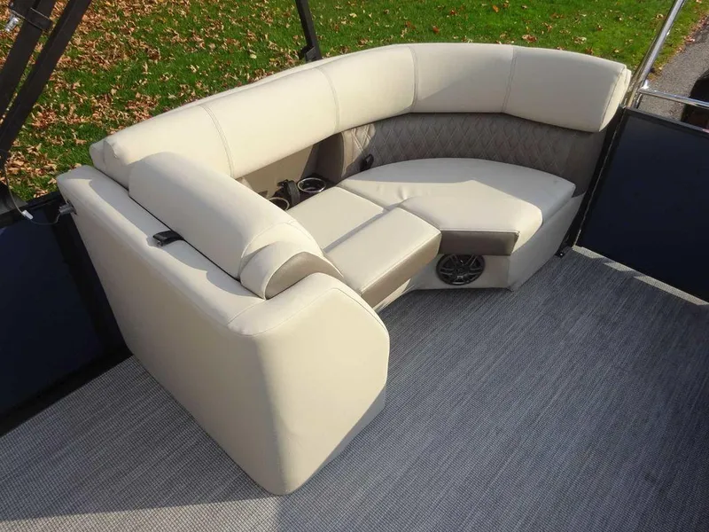 Slide: The Image of 2024 Harris Sunliner 230 boat interior with beige seating and carpet flooring. - 7