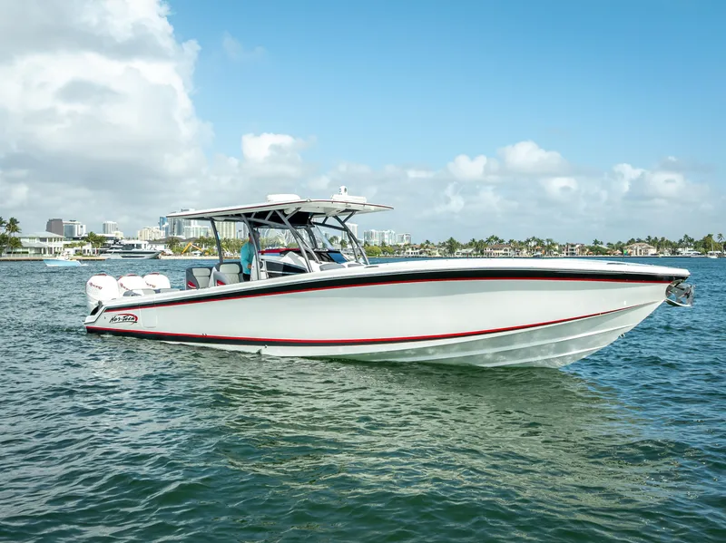 Slide: The Image of 2018 Nor-Tech 390 boat cruising on a sunny day, with clear skies and calm waters. - 0