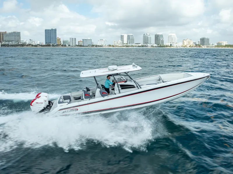Slide: The Image of 2018 Nor-Tech 390 boat cruising on ocean near city skyline. - 13