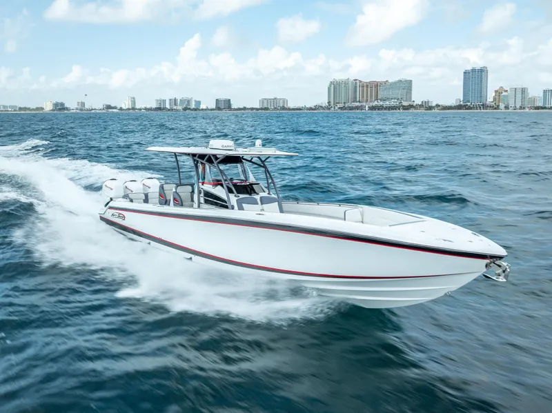Slide: The Image of 2018 Nor-Tech 390 boat cruising on open water with city skyline in background. - 15