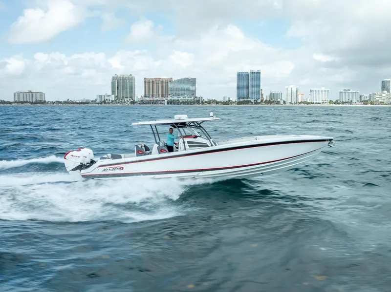 Slide: The Image of 2018 Nor-Tech 390 boat cruising on ocean near city skyline. - 16
