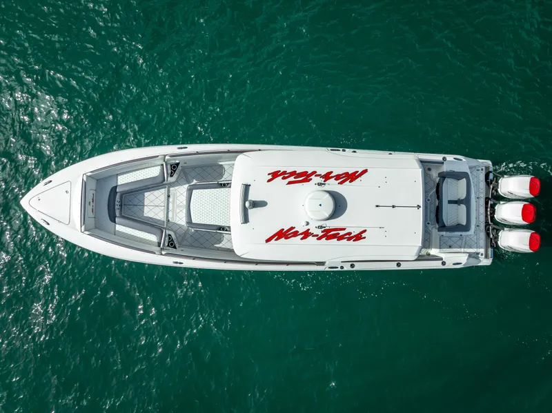 Slide: The Image of 2018 Nor-Tech 390 boat on clear water, aerial view. - 2