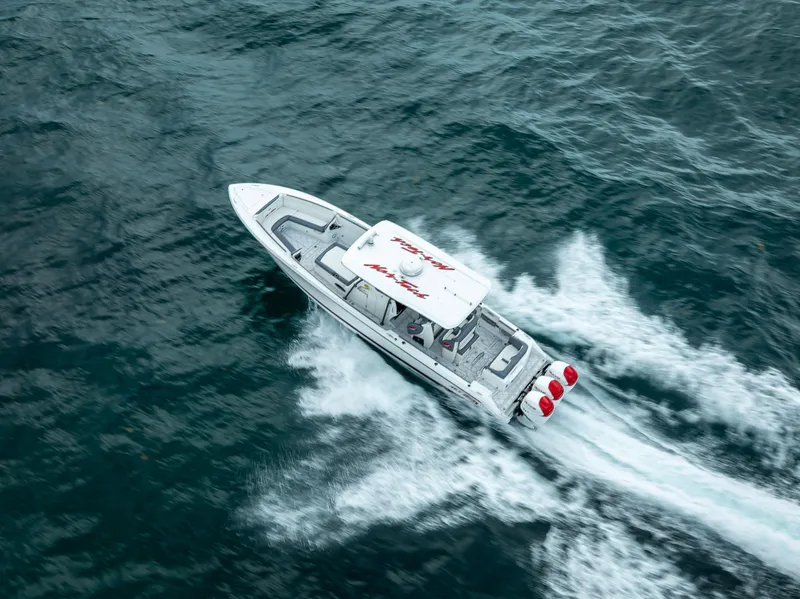 Slide: The Image of Aerial view of 2018 Nor-Tech 390 boat speeding on open water. - 22
