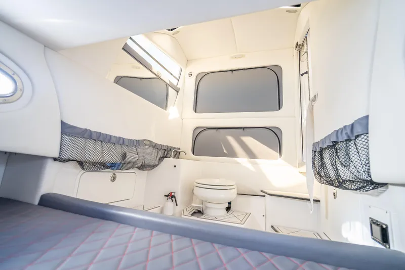 Slide: The Image of 2018 Nor-Tech 390 boat interior with toilet and storage compartments. - 23