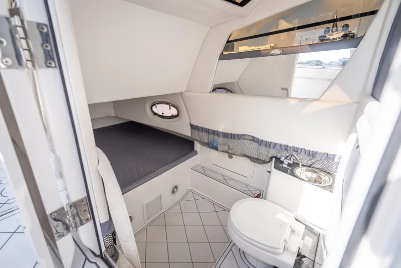Slide: The Image of 2018 Nor-Tech 390 cabin interior with bed, toilet, and sink. - 25