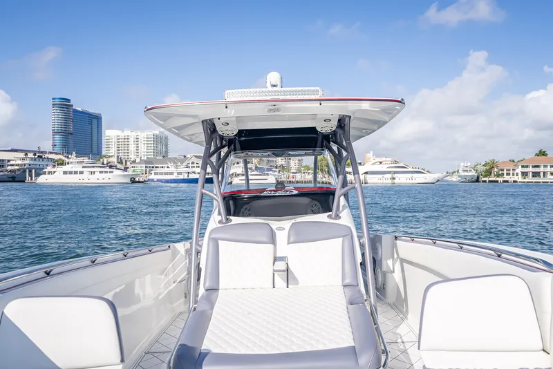 Slide: The Image of 2018 Nor-Tech 390 boat on water, city skyline in background, clear blue sky. - 26