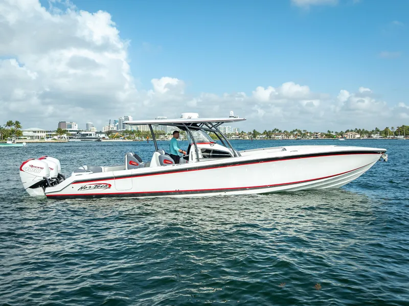 Slide: The Image of 2018 Nor-Tech 390 boat cruising on a sunny day with city skyline in background. - 3