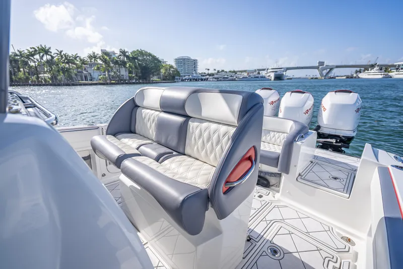 Slide: The Image of 2018 Nor-Tech 390 boat interior with luxurious seating and powerful outboard engines. - 32