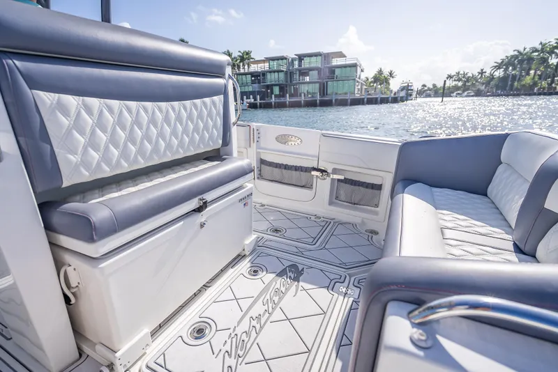 Slide: The Image of 2018 Nor-Tech 390 boat interior with luxurious seating and waterfront view. - 33