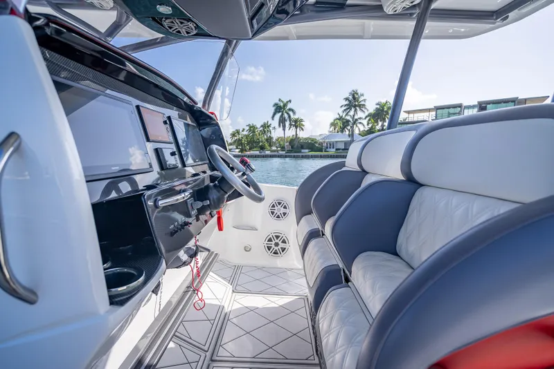 Slide: The Image of 2018 Nor-Tech 390 boat interior with modern dashboard and luxurious seating. - 35