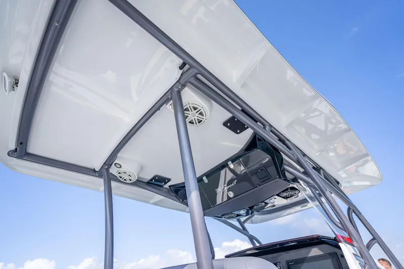 Slide: The Image of 2018 Nor-Tech 390 boat T-top with speakers and electronics against blue sky. - 40