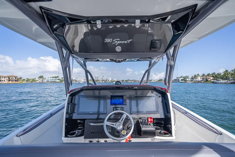 Slide: The Image of 2018 Nor-Tech 390 Sport boat dashboard with navigation screens on open water. - 42
