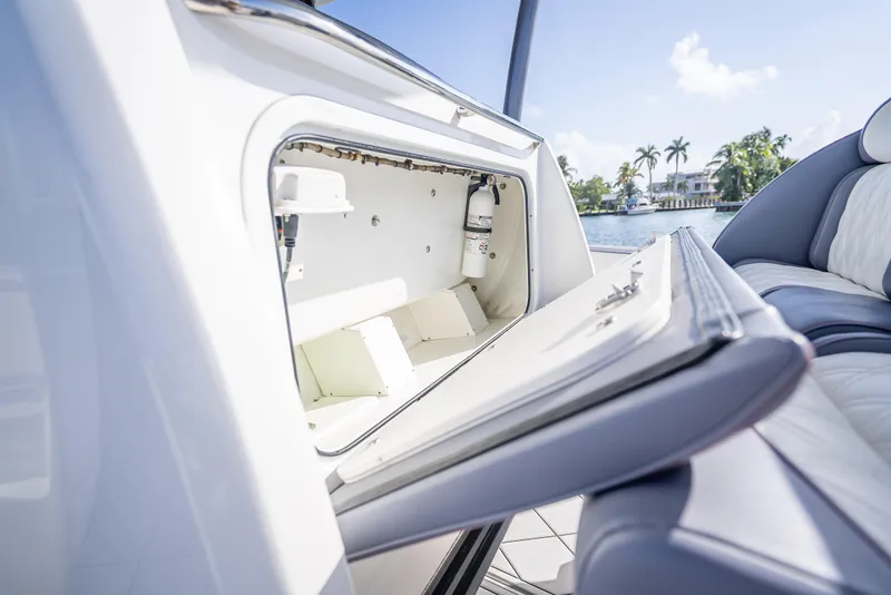 Slide: The Image of Open storage compartment on 2018 Nor-Tech 390 boat, with scenic waterfront view. - 45