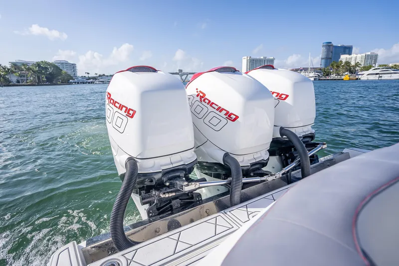 Slide: The Image of 2018 Nor-Tech 390 boat with triple outboard engines on a sunny day. - 46