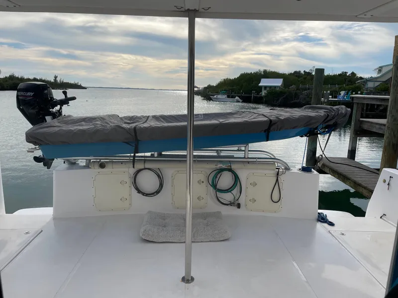 Slide: The Image of 2004 Endeavour Explorer 46 PowerCat docked, featuring covered equipment and scenic waterfront view. - 24