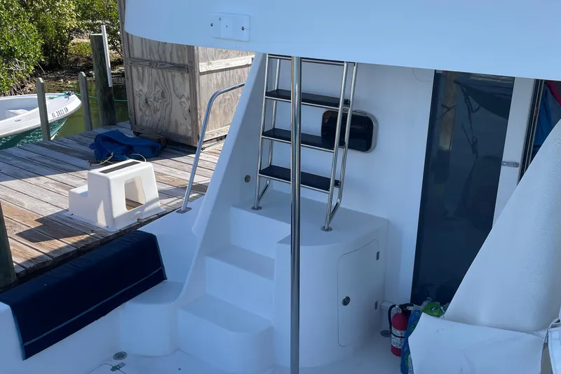 Slide: The Image of 2004 Endeavour Explorer 46 PowerCat boat with ladder and dockside view. - 32