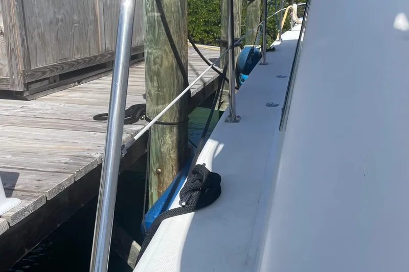 Slide: The Image of Side view of 2004 Endeavour Explorer 46 PowerCat docked at a wooden pier. - 35