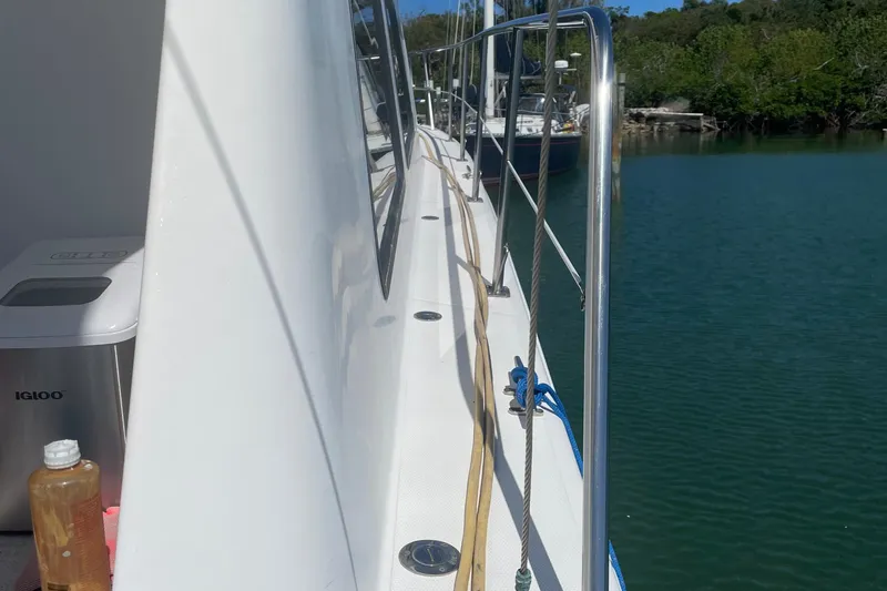 Slide: The Image of 2004 Endeavour Explorer 46 PowerCat docked by lush green shoreline. - 36