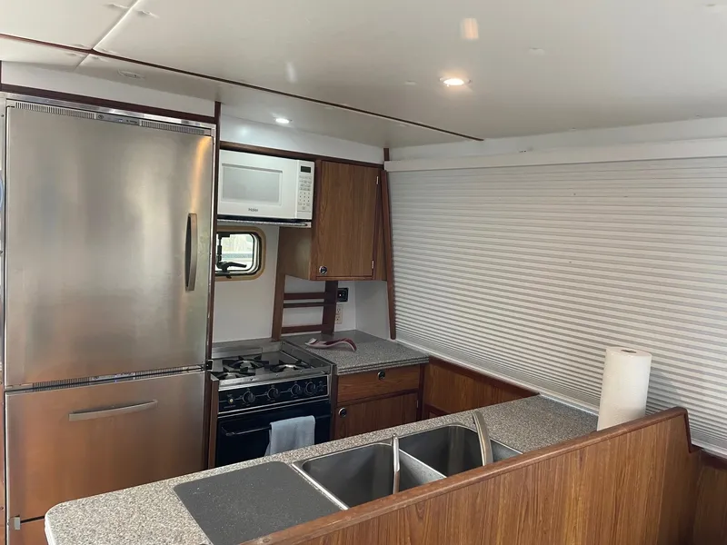 Slide: The Image of 2004 Endeavour Explorer 46 PowerCat kitchen with stainless steel appliances and wooden cabinetry. - 40
