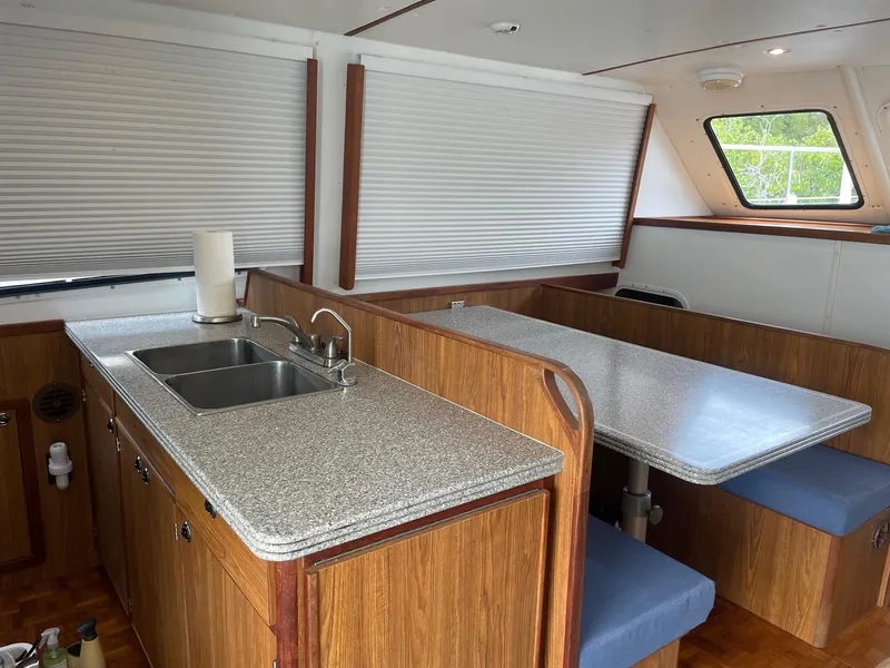Slide: The Image of Interior of 2004 Endeavour Explorer 46 PowerCat with kitchen and dining area. - 43
