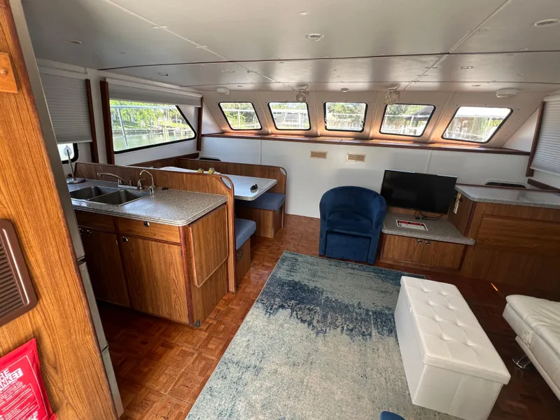Slide: The Image of Interior of 2004 Endeavour Explorer 46 PowerCat with kitchen, seating, and windows. - 45