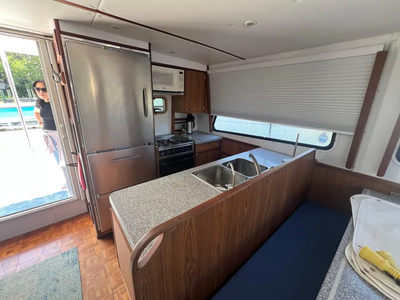 Slide: The Image of Interior of 2004 Endeavour Explorer 46 PowerCat kitchen with stainless steel appliances and wood finish. - 48