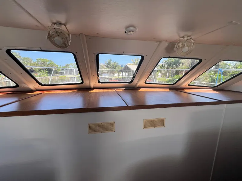 Slide: The Image of Interior view of 2004 Endeavour Explorer 46 PowerCat with large windows and wooden accents. - 49
