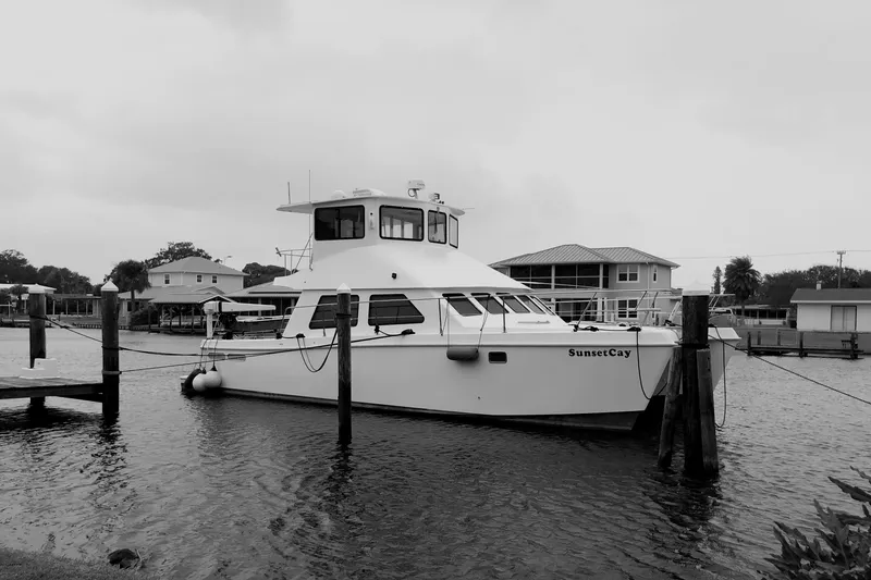 Slide: The Image of 2004 Endeavour Explorer 46 PowerCat docked in a serene waterfront setting. - 9