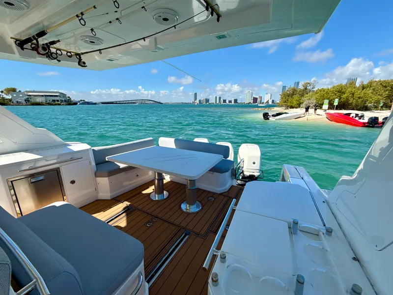 Slide: The Image of Azimut 40 Verve 2019 yacht with elegant deck, overlooking turquoise waters and city skyline. - 10